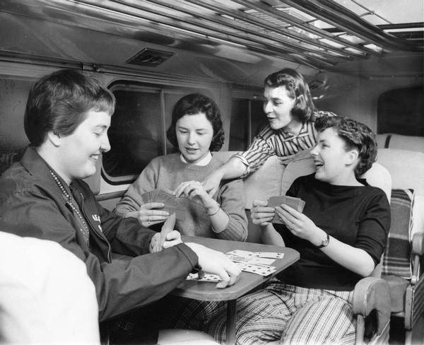 Women playing cards on a bus ride.