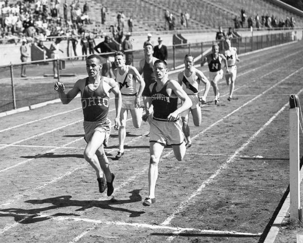 Mal Whitfield approaches the finish line of a track race at the University of Wisconsin Stadium.