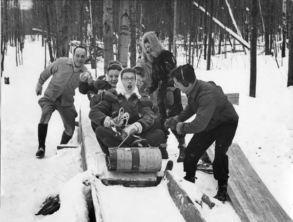 Winter scene with Lawrence College students tobogganing at Rib Mountain near Wausau.
