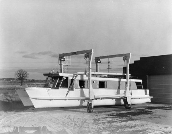 A Carrie-Craft catamaran houseboat on lift at the Carrie-Craft factory.