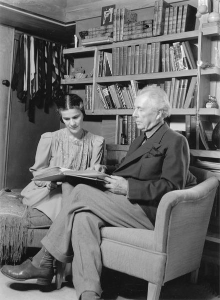 Frank Lloyd Wright and his wife Olgivanna, seated together reading in a bedroom at Taliesin. Taliesin is located in the vicinity of Spring Green, Wisconsin.