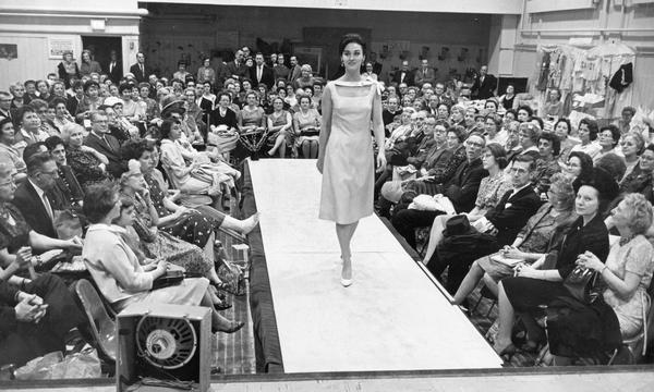 A model walks down the runway during an Easter dress fashion show.  Ticket sales benefitted the University of Wisconsin-Milwaukee community center.