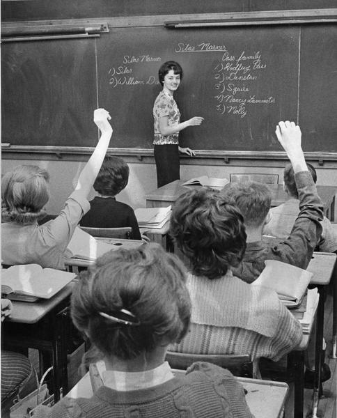 A female student leads a class of fellow students. She is a member of the Future Teachers of America Club.