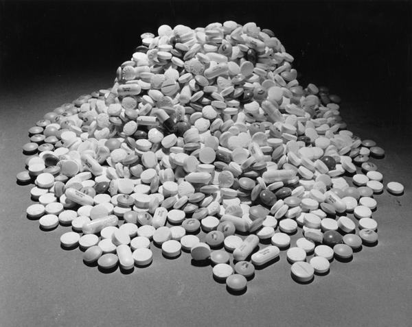 A pile of a variety of pain relievers in tablet and capsule form.