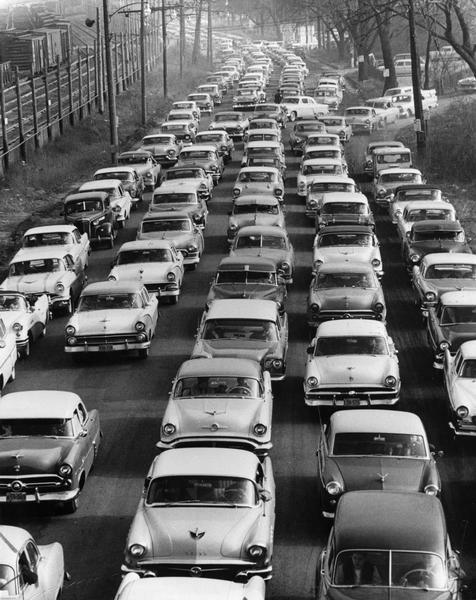 Elevated view of city traffic of bumper-to-bumper cars leaving Milwaukee County Stadium after the 1957 World Series.