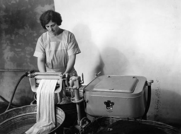 Mrs. Granere wringing clothes with a Maytag washing machine at Harvester Farm.