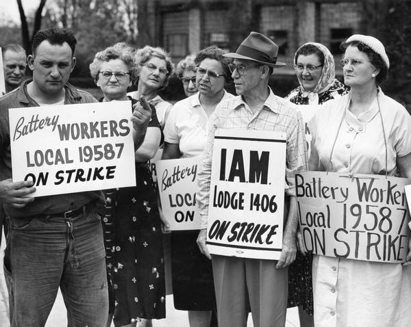 Ray-O-Vac workers from the Battery Workers' Union and Machinists' Union picketing for higher wages, better working conditions, and better pension plan. Anthony "Tony" Caruso stands second from the right, wearing a hat and holding a sign that reads "I.A.M. Lodge 1406 On Strike".