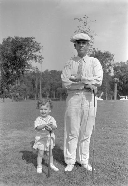 Two generations of the Brandel family pose with golf clubs at the Fox Lake Golf Course.