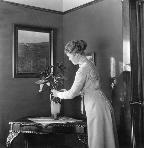 Mary E. Smith, wife of Dr. Joseph Smith, arranges flowers for the holidays.