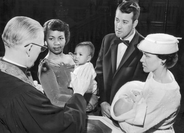 The Reverend Erwin G. Tieman baptizes infants as part of a Lutheran crusade for Christ evangelism.