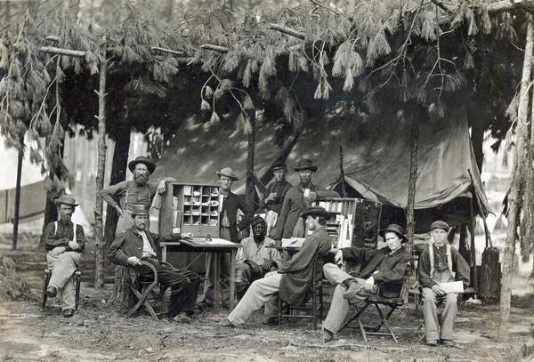 Soldiers relax around the Army Post Office at the quarters of the Chief Ambulance Officer, Ninth Army Corps.