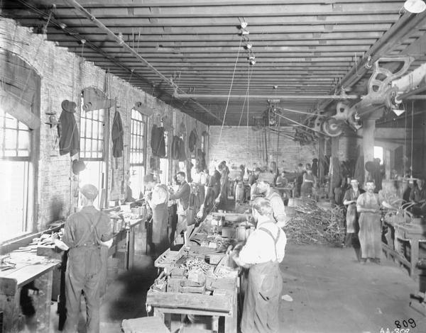 Workers in the metal finishing room at the McCormick Reaper Works. In 1902 the factory became part of the International Harvester Company.