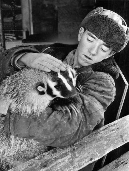 A vocational student holds a badger at The Ranch, a training center for mentally and physically disabled young adults.