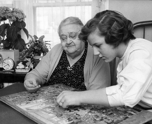 An elderly woman, Josephine Fell, is the "adopted grandmother" to a Girl Scout that visits her and works with her on a puzzle at Rosemary's Nursing Home in Madison.