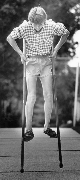 Jay Taylor, age 12, demonstrates his skill on stilts with a walk down E. Nock Street.