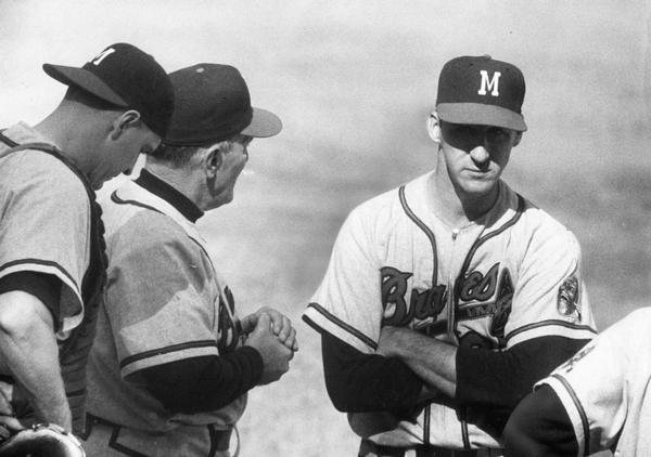 Warren Spahn, pitcher for the Milwaukee Braves, confers with catcher Del Crandall (far left) and manager Fred Haney (left) shortly before he is removed from Game 1 of the 1957 World Series at Yankee Stadium.  Spahn was replaced by Ernie Johnson in the 6th inning.  Spahn and the Braves lost the game 3-1.
