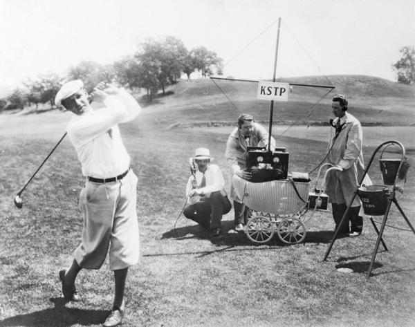 Golfer tees off in the 1930 National Open Golf Tournament at the Interlachen Country Club while KSTP radio broadcasts from their first mobile remote broadcast unit.