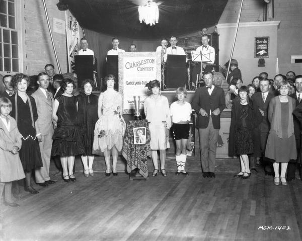 People stand in anticipation of a Charleston dancing contest.