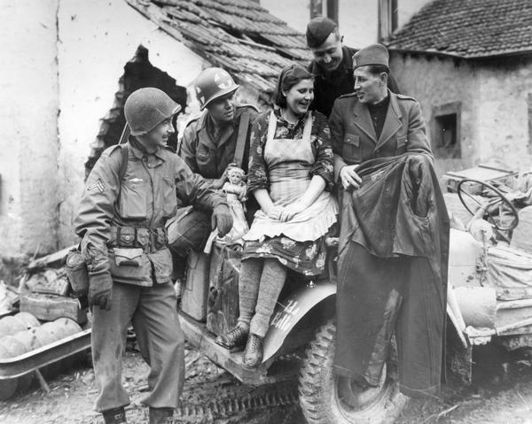 GIs from the U.S. 76th Infantry Division make friends with two Yugoslav soldiers and a Russian woman who were freed from a German prison camp during World War II.