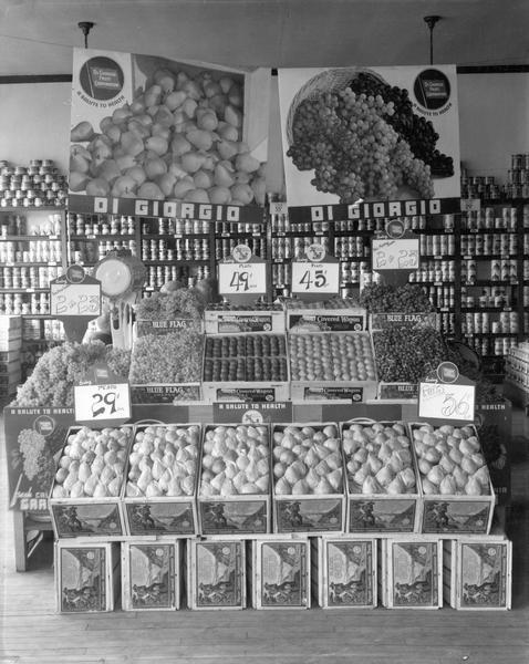 Shelves of canned food provide a backdrop for an array of fresh pears, grapes, and plums at the Frank Bros. market.