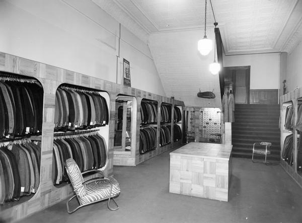 Men's suits and sport coats hang from the racks inside Rundel's Inc. men's store.