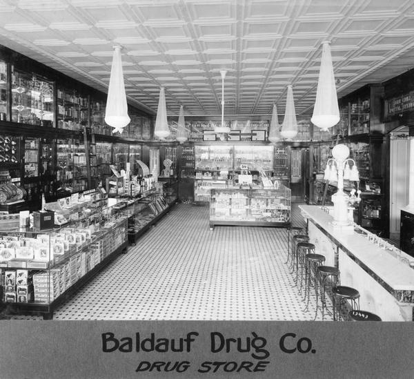 Display cases are neatly arrayed with merchandise inside the Baldauf Drug Company store.