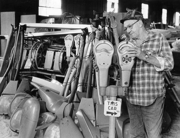 A man looks over parking meters that are some of the items for sale at the first Milwaukee County Recycling Center sale.