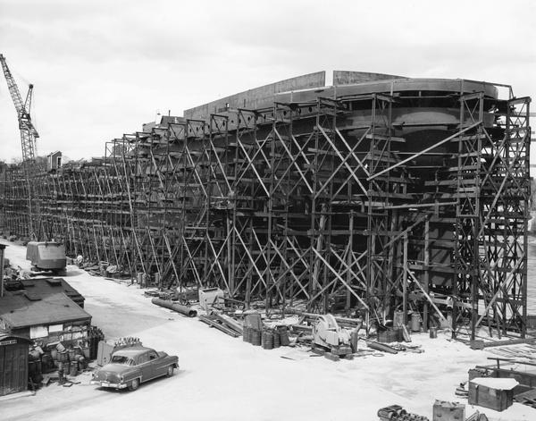 Self-unloader, the Detroit Edison, Hull 418, is under construction and surrounded by scaffolding at Manitowoc Shipbuilding Corporation.