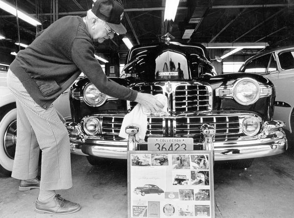 A man polishes his 12-cylinder Lincoln Coupe as part of a classic car show at Rank & Son Buick-GMC Truck.