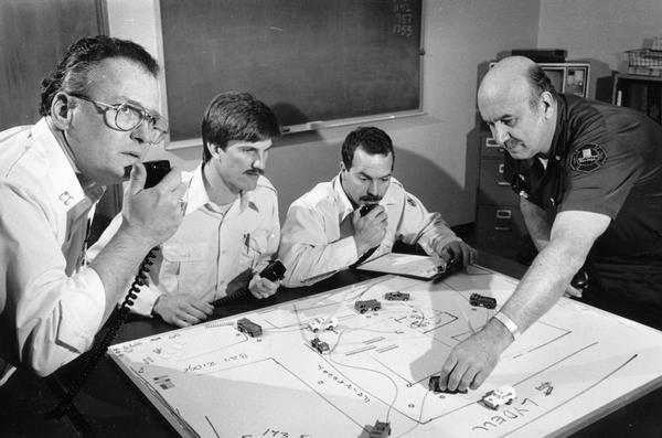 Fire fighters use a board game to simulate conditions at a fire scene as part of their training.