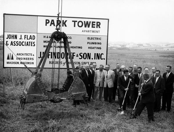 Developers, local dignitaries, and other businessmen participate in a ground-breaking ceremony for the construction of the Park Tower Apartments.