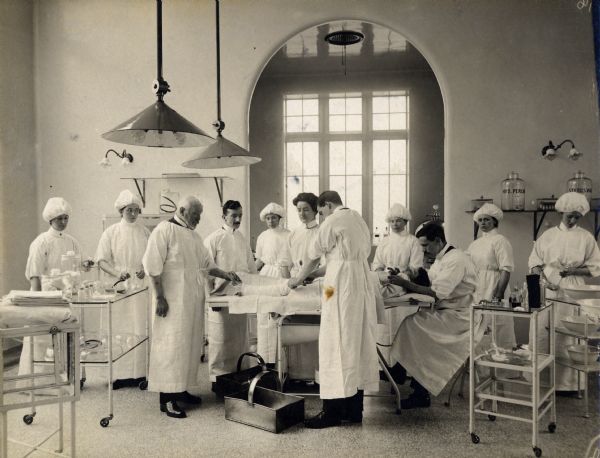 Doctors and nurses surround a patient on a gurney in an operating room at Stobhill General Hospital in Glasgow, Scotland.
