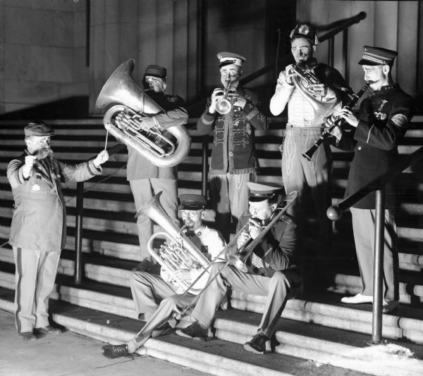 A maestro leads shriner musicians from the Zor Shrine German Band as they play their instruments on the steps of the Masonic Temple on Wisconsin Avenue.