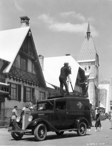 Photographer from Kaufmann and Fabry on top of an International C-1 truck at the "A Century of Progress" Worlds Fair. Kaufmann and Fabry were the official photographers of the "A Century of Progress." The truck operated continuously within the fairgrounds.