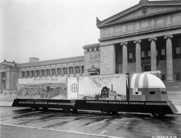 International Harvester Company parade float for the "A Century of Progress" Worlds Fair. The two-section float is parked in front of the Field Museum and reads: "McCormick's First Chicago Reaper Works, 1847, Annual Capacity 500 Reapers," and "McCormick Works, 1934, World's Largest Farm Machine Factory."