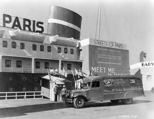 International A-5 beer truck in front of "Streets of Paris" ocean-liner attraction at the "A Century of Progress" Worlds Fair. The truck was owned by Chas H. Wieber Distributing Company and advertises Canadian White Horse Ale and Schlitz beers.