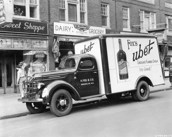 International D-35 box panel truck delivering Fox's Ubet chocolate flavored syrup to a "Sweet Shoppe." The truck was owned by H. Fox & Company, 283 Christopher Street, Brooklyn, New York.