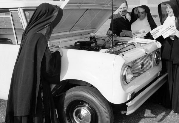 Nuns from Trenton are introduced to an International Scout truck by International Harvester Branch Manager Ziemer. The truck was given to the Sisters of Mercy to provide transportation on their mission to serve impoverished Costa Rican settlers in San Vito de Java.