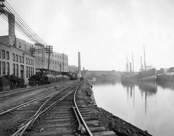 International Harvester's Deering Works as seen from railroad tracks near the waterfront. The factory was located at Fullerton and Clybourn Avenues, across the river from the Claney-Bishop Lumber Co. The factory was originally built by William Deering for the Deering Harvester Company in 1880. In 1902 it became International Harvester's Deering Works. The factory was located at Fullerton and Clybourn Avenues and closed in 1933.