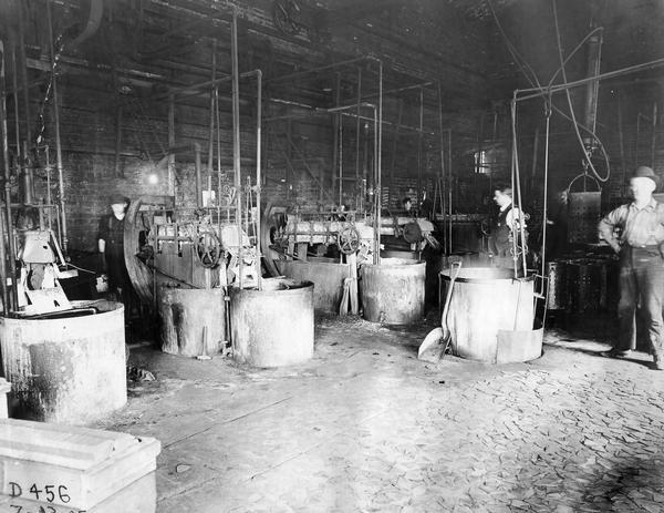 Factory workers mixing paint at International Harvester's Deering Works. The factory was operated by the Deering Harvester Company until it became part of International Harvester in 1902.