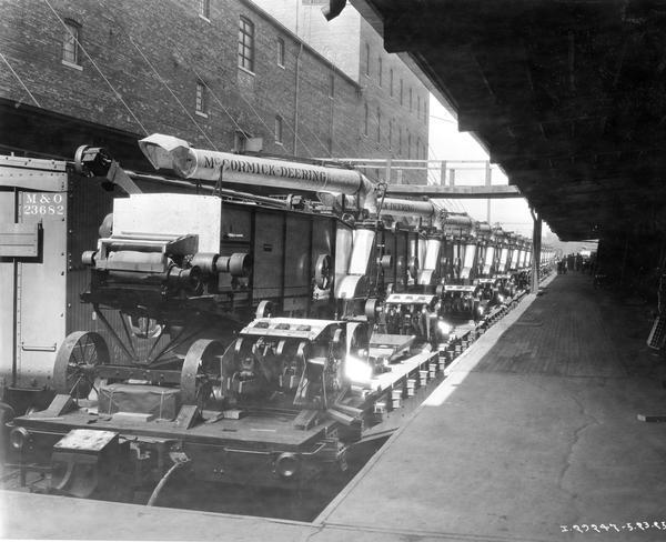 McCormick-Deering all-steel threshers loaded on railroad cars outside International Harvester's West Pullman Works (factory). The factory originally belonged to the Plano Manufacturing Company.