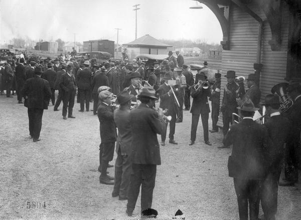 Twelve piece brass band playing at a railroad station during the "Union Pacific Preparedness Special Campaign."