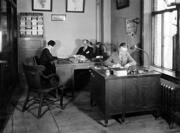 Three employees of the Publicity Division of International Harvester's Agricultural Extension Department: Mr. Cooley, Mr. Remley and Miss McNulty.