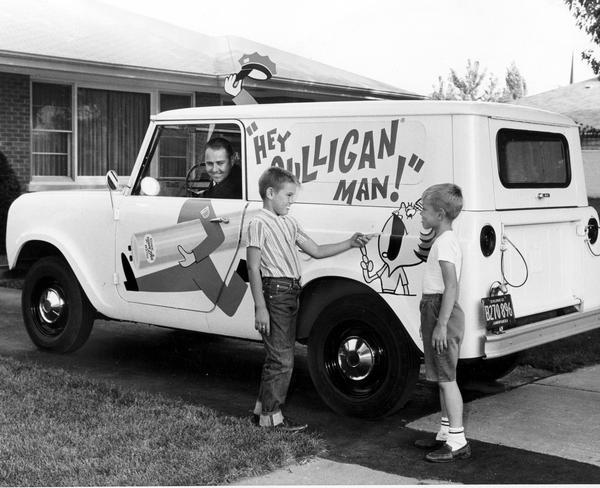 Two young boys point to an advertising illustration on an International Scout owned and operated by Culligan, Inc.