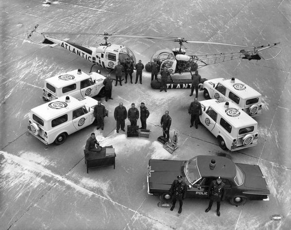 Elevated view of four International Scouts, one patrol car, and two helicopters used by Atlantic Go Patrol, Philadelphia's traffic patrol.
