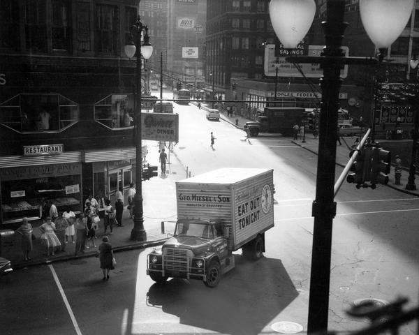 Elevated view of an International 1700 Loadstar truck owned by George Miesel and Son, wholesale grocers, delivering daily foodstuffs to restaurants and institutional customers.