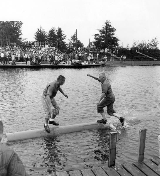 Two men competing in a log rolling contest.
