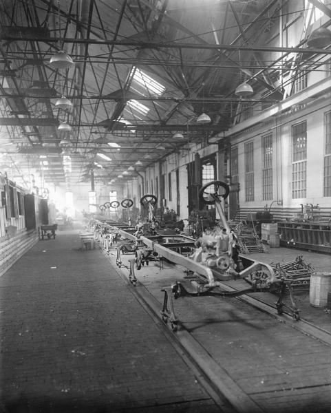 Truck chassis on an assembly line at International Harvester's Akron Works. The factory was owned by the Aultman & Miller Buckeye Company until the company was purchased by International Harvester in 1905. The factory burned in 1907 but was rebuilt in 1912.