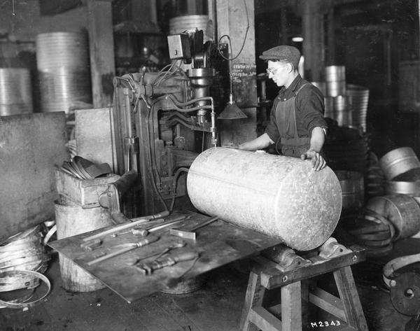 Worker assembling a tank at International Harvester's Milwaukee Works. The factory was owned by the Milwaukee Harvester Company until 1902.