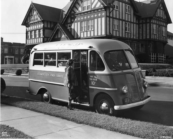 Woman wearing a mink coat boarding an International Metro KB-3-M truck owned by Atlantic City Jitney Service.